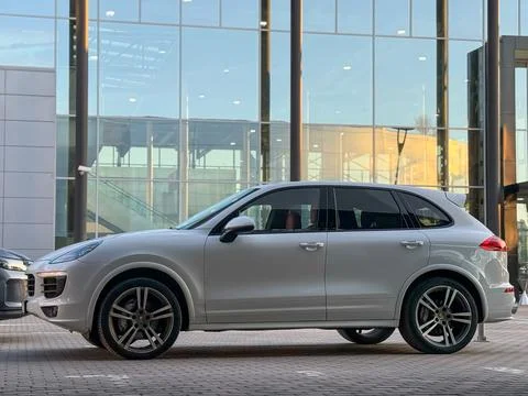 White Porsche Cayenne S E2 958 sports SUV in parked lot. Stock Photos