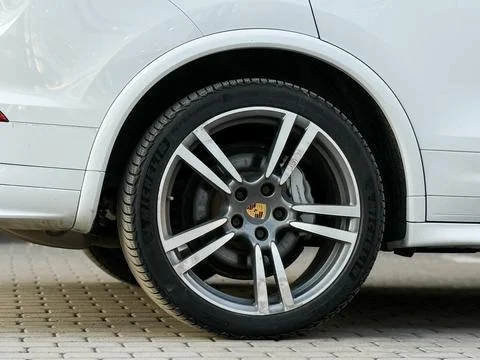 White Porsche Cayenne S E2 958 sports SUV in parked lot. Stock Photos