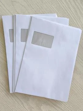 White postal envelopes with address window Stock Photos