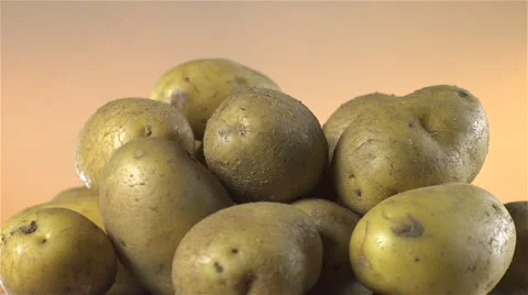White Potatoes isolated rotating on brown background. Stock Footage 63340411