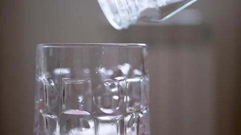 White Powder Being Poured into Empty Glass Stock Footage 317561871