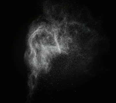 White powder exploding isolated on black Stock Photos