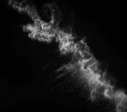 White powder exploding isolated on black Stock Photos