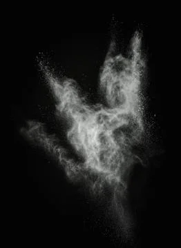 White powder exploding isolated on black Foto stock