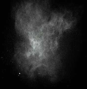 White powder exploding isolated on black Stock Photos