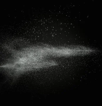 White powder exploding isolated on black Stock Photos