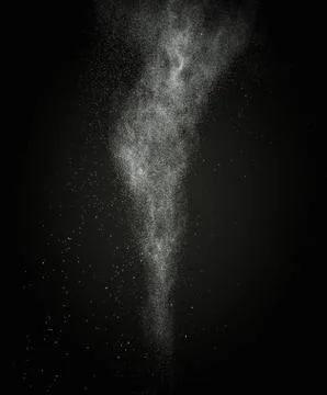 White powder exploding isolated on black 写真素材