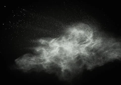 White powder exploding isolated on black Foto stock