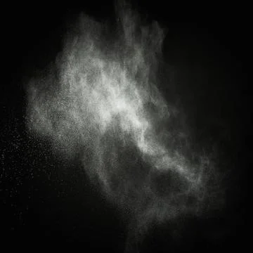 White powder exploding isolated on black Stock Photos