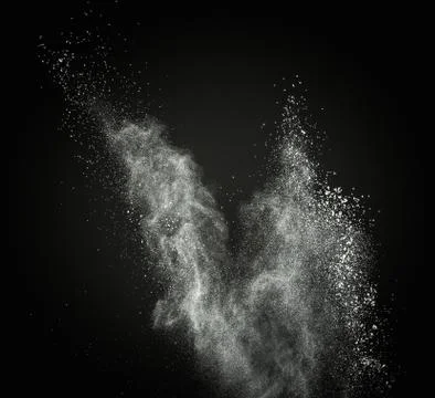 White powder exploding isolated on black Foto stock