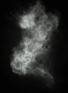 White powder exploding isolated on black Foto stock