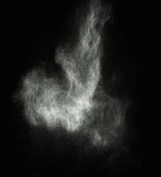 White powder exploding isolated on black Stock Photos