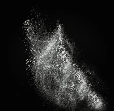 White powder exploding isolated on black 写真素材