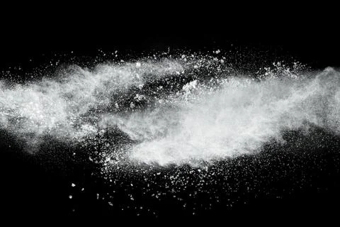 White powder explosion cloud against black background. Stock Photos