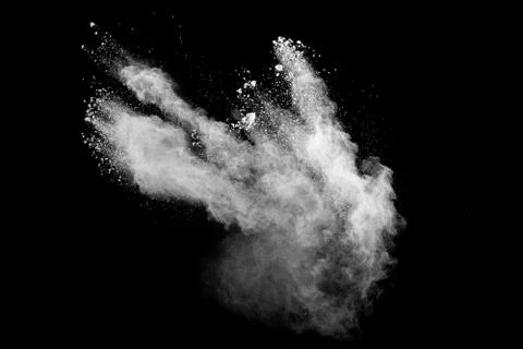 White powder explosion cloud against black background.White dust particle. Stock Photos