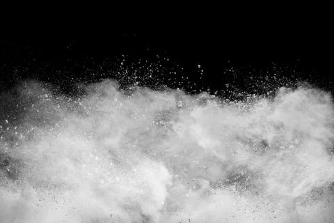 White powder explosion cloud against black background. Stock Photos