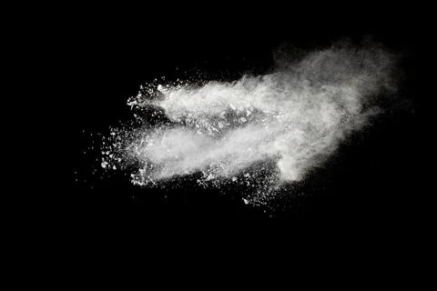 White powder explosion cloud against black background.White dust particle. Foto stock