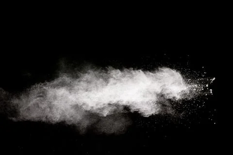 White powder explosion cloud against black background.White dust particle. Stock Photos