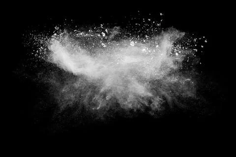 White powder explosion cloud against black background. White dust particles. Foto stock