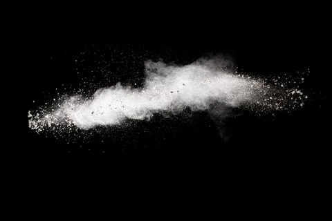 White powder explosion cloud against black background. White dust particles. 写真素材