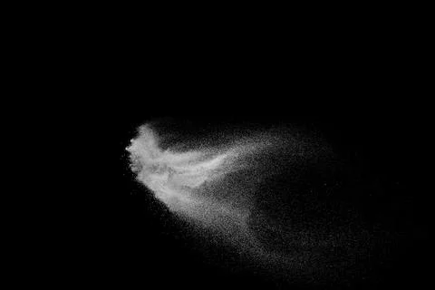 White powder explosion cloud against black background.White dust particles. Stock Photos