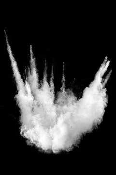 White powder explosion cloud against black background.White dust particles. Stock Photos