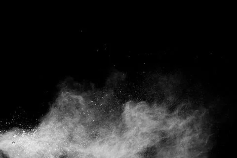 White powder explosion cloud against black background. Stock Photos