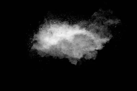 White powder explosion cloud against black background.White dust particle ... Foto stock