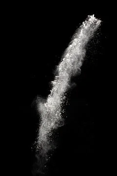 White powder explosion cloud against black background.White dust particles .. Stock Photos