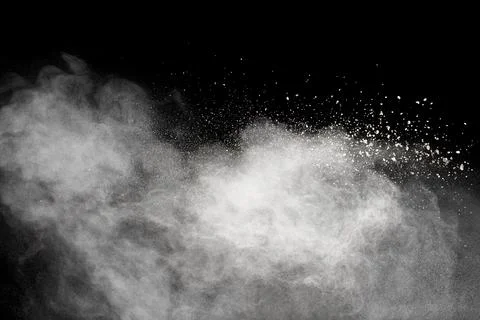 White powder explosion cloud against black background.White dust particles .. Stock Photos