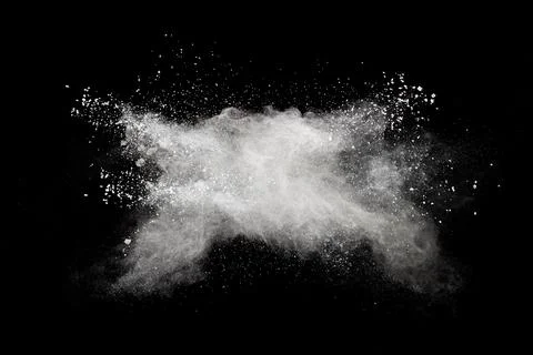 White powder explosion cloud against black background.White dust particles .. Stock Photos