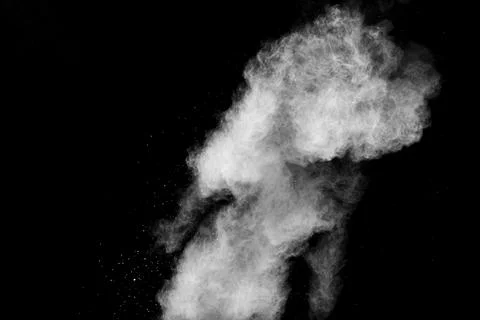 White powder explosion isolated on black background.White dust particle. Stock Photos