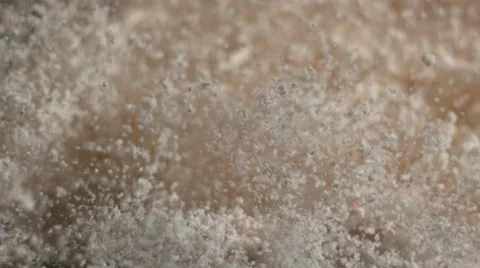 White powder particles bounce off canvas from an impact and fall in slow motion Stock Footage 64017943