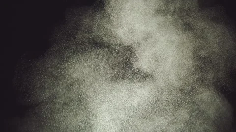 White powder particles exploding upward against black background in cinemat.. Stock Footage 337440999