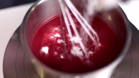White powder is poured into a container with red liquid Stock Footage 275146185