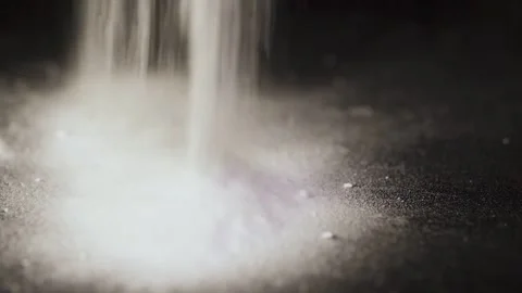 White Powder Pouring on Black Background Close Up Isolated 動画素材 334563208