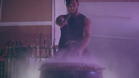 White powder rising while a man is hitting a drum Stock Footage 279825579