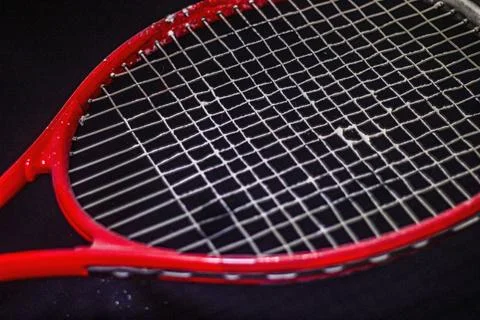 White powder on the strings of a red racket 스톡 사진