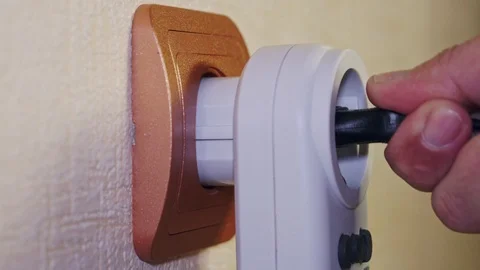 White power meterelectric plug stick in and out the orange socket Stock Footage 102913485