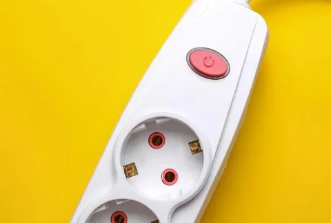 White power strip with red switch on yellow background Stock Photos