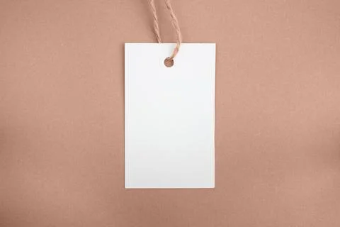 White price tag on a brown background. Mockup. Place for text. Stock Illustration