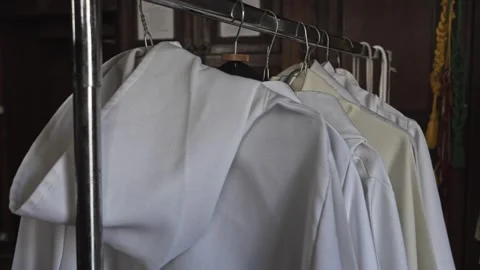 White priest's tunics hanging. 库存影片 249263176