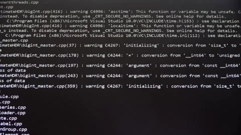 White programming code scrolling on a black screen while compiling a large C Stock Footage 348611997