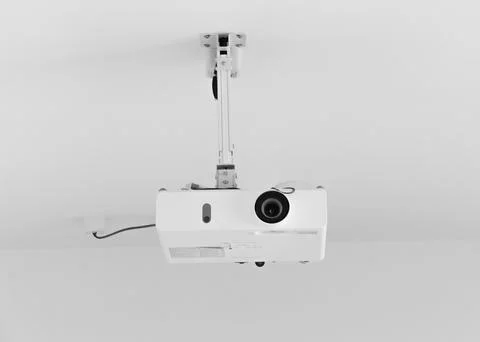 White projector hangs on the ceiling Stock Photos