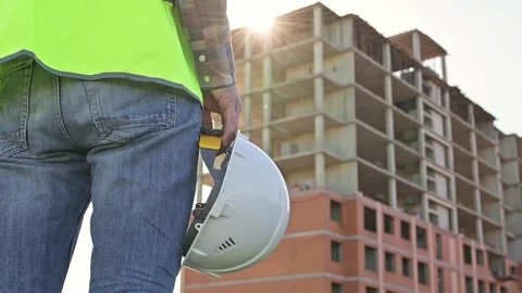 White protective helmet in the hands of a builder, engineer, architect, designer Stockbeeldmateriaal 201364785