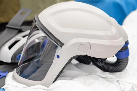A white protective helmet with a transparent screen is used to filter the air 스톡 사진