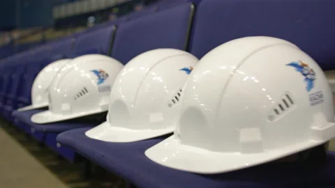 White protective helmets on spectator places at stadium Stock Footage 238931862