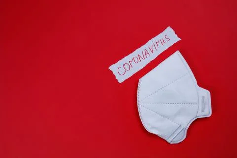 White protective mask on a red background Stock Photos
