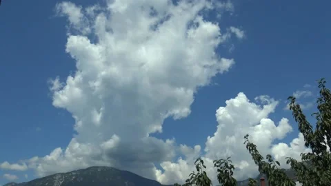 White puffy clouds against a dark blue sky fast timelapse Stock Footage 159074170