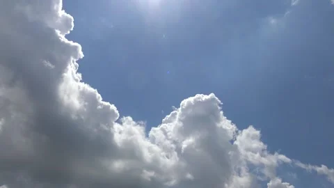 White puffy clouds against deep blue sky timelapse Stock Footage 159079374